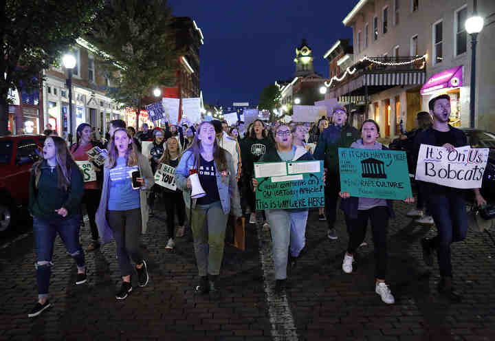 With a police escort, hundreds of Ohio University students march down Court Street in Athens, Ohio in an effort to raise awareness of sexual assault on campus prior to a rally on the College Green on Sept. 27, 2018.   (Adam Cairns / The Columbus Dispatch)